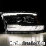 AlphaRex 09-18 Ram 1500HD LUXX Proj Headlight Plnk Style Jet Blk w/Activ Light/Seq Signal/Smoked DRL AlphaRex Headlights  AXOPROS